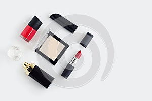 Set of luxury cosmetics, red lipstick, nail polish, powder, perfume on white background