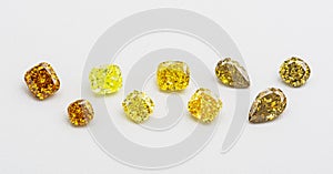 Set of luxury yellow and brown transparent sparkling gemstones of various cut shape diamonds collage on white background