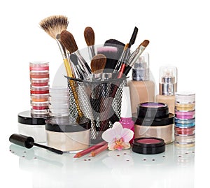 Set of makeup brushes: eye shadow, blush, foundation, nail polish and cream isolated on white