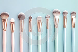 Set of makeup brushes on pink and aqua colored composed background photo