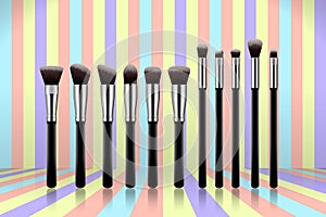 Set of makeup brushes, professional makeup kit concealer powder eyebrush with black handles on colorful pastel background.