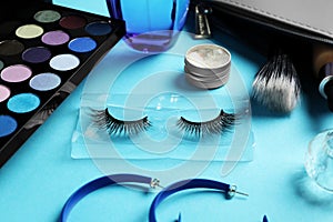 Set of makeup products on light blue background
