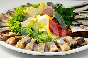 The set marinated mackerel,erring, herring fillet, sprat at Borodino bread, on the plate