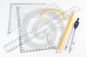 Set of mathematics school tools on squared paper