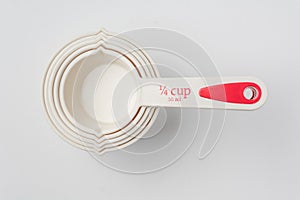 Set of Measuring Cups Stacked on White Background Close Up