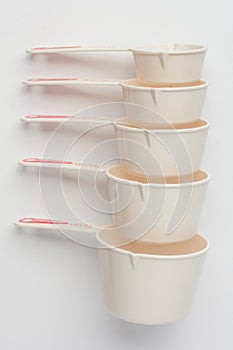 Set of Measuring Cups Stacked on White Background Top View