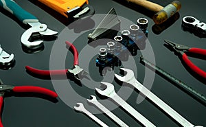 Set of mechanic tools on dark background. Chrome wrenches or spanners, hexagon socket, end cutter pliers, locking pliers, pincers