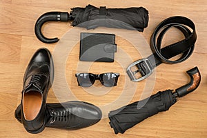 Set of men`s fashion accessories lying on the laminate.