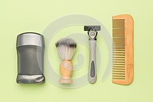 A set of men\'s hygiene items on a light green background
