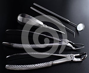 Set of metal medical equipment tools for teeth dental care isolated on black