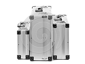 Set of metal suitcases of different sizes isolated on white background