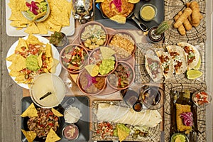 set of mexican dishes with nachos, tacos, quesadillas, wire, tequeÃÂ±os, guacamole, pico de gallo, tamal photo