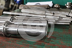 A set of milling cutters on a rack near a lathe. Metalworking cutting mills for CNC machines. Industrial processing of metal