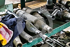 A set of milling cutters on a rack near a lathe. Metalworking cutting mills for CNC machines. Industrial processing of metal