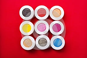 Set of mineral eye shadows on red background