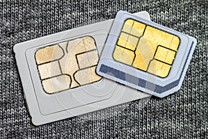 Set of mini and micro simcard. Isolated on grey cloth texture ba