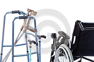 Set of mobility aids including a wheelchair, walker, crutches, quad cane, and crutches. photo