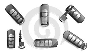 Set of modern car keys on white background