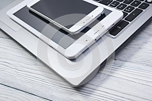 Set of modern computer devices - laptop, tablet and phone close up