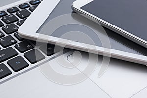 Set of modern computer devices - laptop, tablet and phone close up