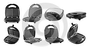 Set with modern electric waffle makers on background