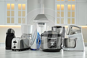 Set of modern home appliances on marble table in kitchen