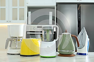 Set of modern home appliances on marble table in kitchen