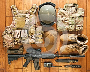 Set of modern military equipment on wooden background