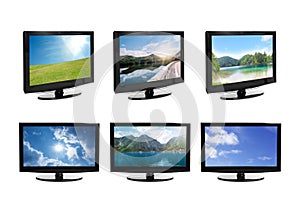 Set of modern plasma TVs with landscape on screens against background