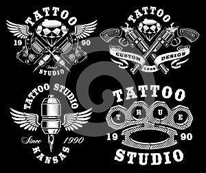 Set of monochrome tattoo emblems on dark background