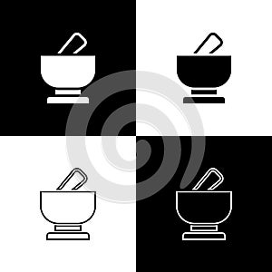 Set Mortar and pestle icon isolated on black and white background. Vector