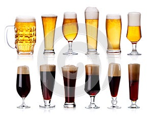 set of mugs and glasses with light and dark beer isolated on white