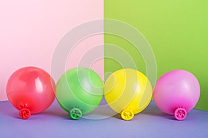 Set of multi colored air balloons on pastel minimal background.