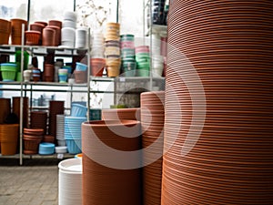 Set of multi-colored empty pots for plants. The brown pots put by a pile. Flowerpots for houseplants