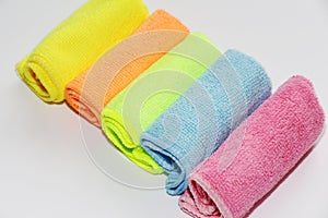 Set of multi-colored microfiber rags for cleaning. Five colored towels on a white background