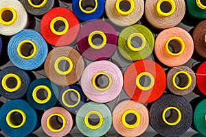 Set of multi-colored spools of thread for sewing
