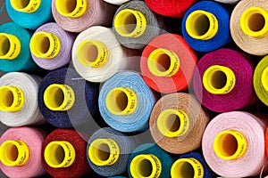 Set of multi-colored spools of thread for sewing