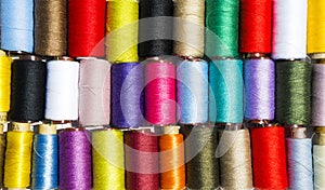 Set of multi-colored thread for sewing, background.