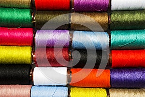Set of multi-colored thread for sewing, background.