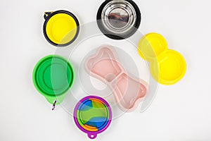 Set of multicolored bowls for food and water for cats and dogs. Bowls from different materials -steel, rubber, plastic