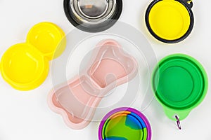 Set of multicolored bowls for food and water for cats and dogs. Bowls from different materials -steel, rubber, plastic