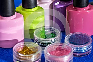 set of nail glitters and polish nail of different colors,
