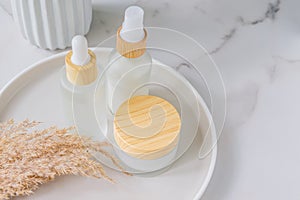 Set of natiral organic cosmetics on a cereamic tray with dry pampas grass boucuet. Skandinavian style decor. Nordic cosmetics photo