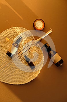 Set of natural organic SPA beauty products on rattan plate in sunlight of sunset