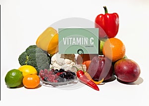 A set of natural products rich in vitamin C ascorbic acid. Healthy food concept. Cardboard sign with the inscription.