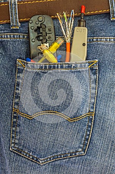 set of network instruments in a back pocket of jeans