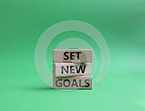 Set New Goals symbol. Wooden blocks with words Set New Goals. Beautiful green background. Business and Set New Goals concept. Copy
