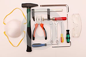 A set of new hand tools, mask, glasses and gloves on a white background