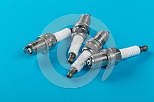 A set of new spark plugs a blue background