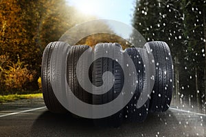 Set of new winter and summer tires on asphalt road, collage